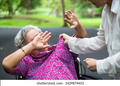 Asian Elderly Woman Were Physically Abused ,attacking In Outdoor Park,angry Young Woman Raised Punishment Fist,stop Physical Abuse Senior People,caregiver,family Stop Violence And Aggression Concept