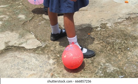 Asian Elementary School Children's Games, Balloon Stomp. The Balloons Are Tied At The Ankle.