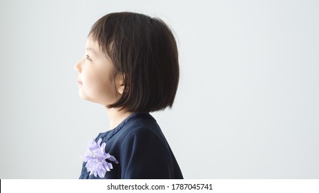 Asian Elementary School Girl On The White Background