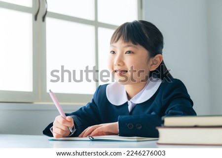 Asian elementary school student studying in the classroom.