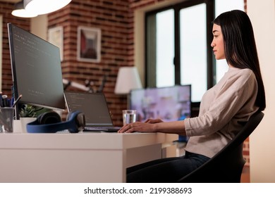 Asian It Engineer Coding Software App With Html Script, Using Firewall Server Encryption For Web App Development. Female Coder Programming New User Interface On Multiple Monitors.