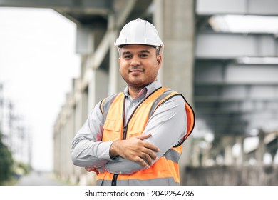 Asian engineer handsome man or architect looking construction with white safety helmet in construction site. Standing at highway concrete road site. - Shutterstock ID 2042254736