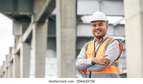 Asian engineer handsome man or architect looking construction with white safety helmet in construction site. Standing at highway concrete road site. - Shutterstock ID 2044635758