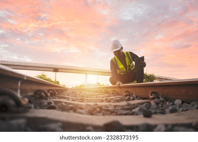 Asian engineer inspects trains Construction workers on the railway Engineer working on railway depot maintenance