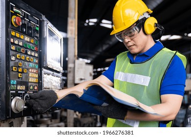 Asian Engineer Male Worker Maintaining Electronics Of Machine At The Industry Factory. Factory Worker Check Or Maintenance CNC Machine In Industry Factory