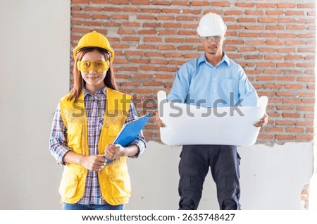 Asian engineer man brainstorming construction building contractor civil worker parners team meeting at constrcution site. Blueprint engineer hardhat worker helmet on table. Engineer teamwork consult