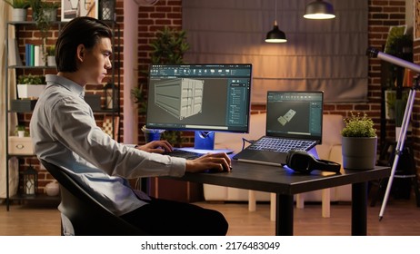 Asian engineer manufacturing industrial product on pc software, using computer screen to develop technical machine component and container. Manufactory blueprint interface. .