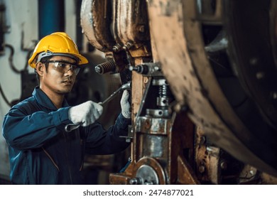 Asian engineer mechanic man checking and using wrench for maintenance pressing metal machine at factory, worker at industrial working	 - Powered by Shutterstock