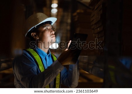 Asian engineer at power station using digital tablet working night shift at petroleum oil refinery in engineering industrial estate Fuel, renewable energy, industrial plants.