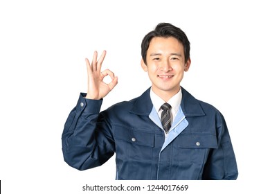 Asian engineer showing OK hand sign.