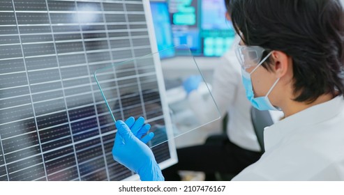 asian engineer team are working with computer and a man examining solar panel through transparent screen tablet in office - Powered by Shutterstock