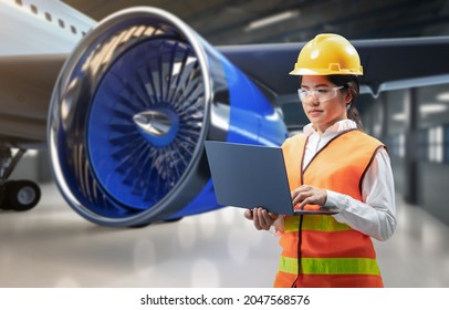 Asian engineer or technician with airplane in hangar - Powered by Shutterstock