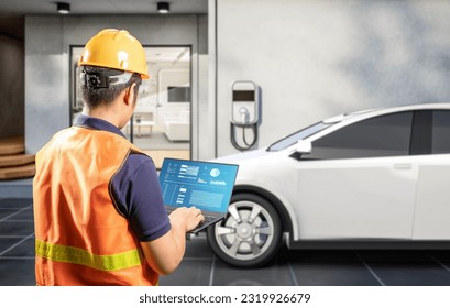 Asian engineer or technician install home ev charger - Shutterstock ID 2319926679