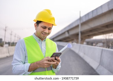Asian Engineer Worker Using Smartphone At Construction Site