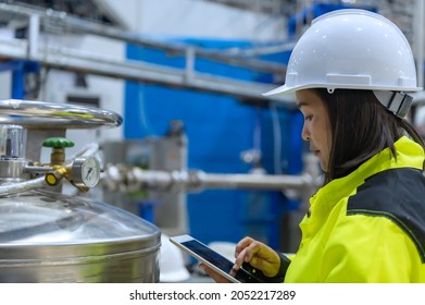 Asian engineer working at Operating hall,Thailand people wear helmet  work,He worked with diligence and patience,she checked the valve regulator at the hydrogen tank. - Powered by Shutterstock