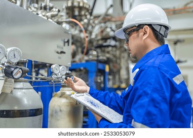 Asian engineer working at Operating hall,Thailand people wear helmet  work,He worked with diligence and patience,she checked the valve regulator at the hydrogen tank. - Powered by Shutterstock