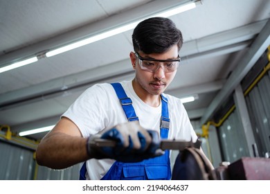 Asian Engineers Or Asian Technicians Work In Industrial Plants. Metal Grinding Machines. Working In The Factory Workers Working In The Factory. Work Factory Industrial Concept.