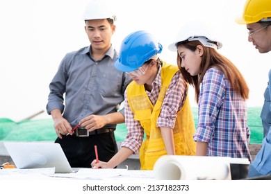 Asian Engineers Were Consulted Together And Plan On The Meeting Outdoor In Construction Site, Engineering And Technology Concept