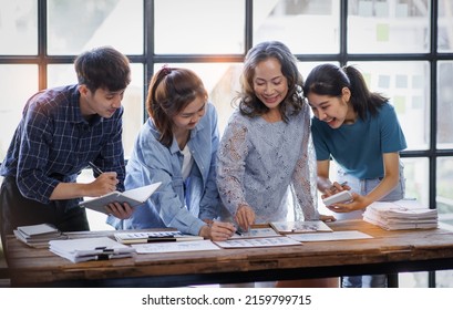 Asian entrepreneur Team of small company drawing a diagram in office during team meeting discussing and analyzing the business situation new startup project in modern loft.  - Shutterstock ID 2159799715