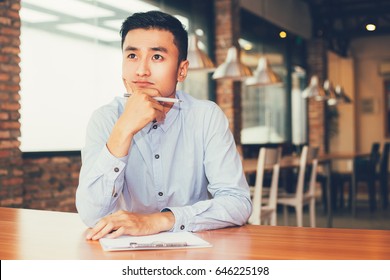 Asian Entrepreneur Thinking On Project In Cafe