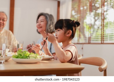 Asian Extended Family Having Breakfast Together At Home. Asian Big Family Grandparents Parents And Kid Enjoy Eating And Talking With Happy Moment.