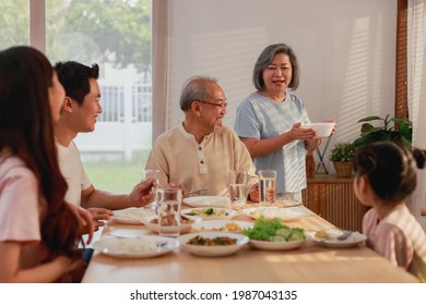 Asian Extended Family Having Breakfast Together At Home. Asian Big Family Grandparents Parents And Kid Enjoy Eating And Talking With Happy Moment.