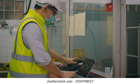 Asian Factory Worker Man Offering Phone Receiver As Business Communication, Technician Man Helmet At Work In Control Room Station Talking On Telephone,