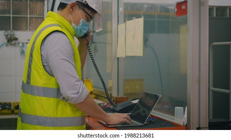 Asian Factory Worker Man Offering Phone Receiver As Business Communication, Technician Man Helmet At Work In Control Room Station Talking On Telephone,