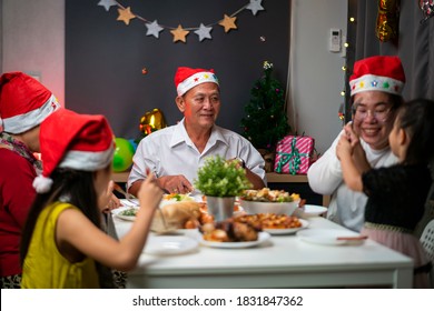 Asian Family Celebrate Christmas And New Year Party Dinner In Christmas Evening. A Cheerful With Grandparent And Family Spend Quality Time Together 