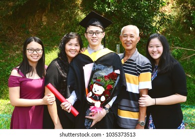 Asian Family Celebrate Graduation Outdoor For Family Member