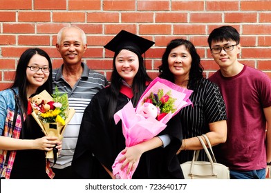 Asian Family Celebrate Graduation Outdoor For Family Member