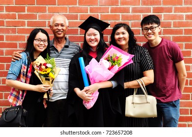 Asian Family Celebrate Graduation Outdoor For Family Member