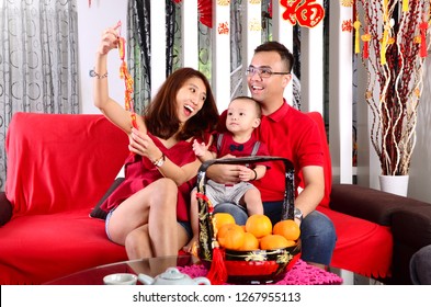 Asian Family Celebrating Chinese New Year. Chinese Characters In The Photo Means 