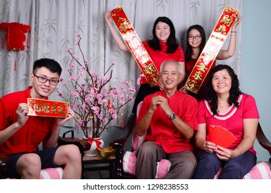 Asian Family Celebrating Chinese New Year.Chinese Characters In The Photo Means 