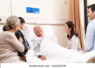 asian family with child visiting grandparents in hospital