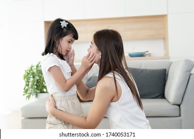Asian family consoling together, mother and kids or little girl touch cheek and talking about soothe sad problem topic