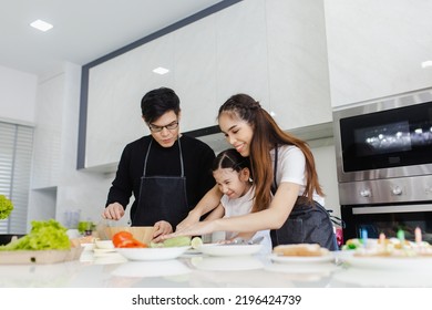 Asian Family Cooking At Home. Happy Family Cooks Together In The Kitchen Home Recreation And Weekend Meal Prep.