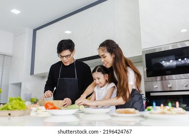 Asian Family Cooking At Home. Happy Family Cooks Together In The Kitchen Home Recreation And Weekend Meal Prep.