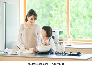 Asian Family Cooking In The Kitchen.