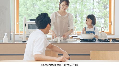 Asian Family Cooking In The Kitchen.