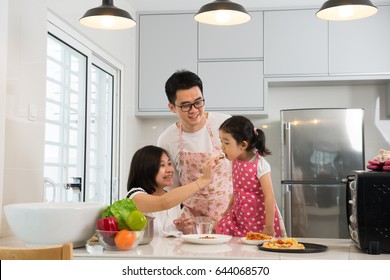 Asian Family Cooking At Kitchen

