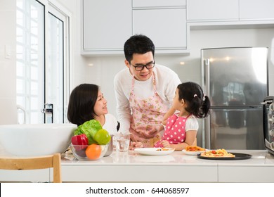 Asian Family Cooking At Kitchen

