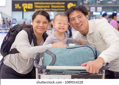 Asian Family With Cute 18 Months / 1 Year Old Toddler Baby Boy Child In Airport Before Boarding At The Public Airport, Family Travel, Vacation With Kid Concept