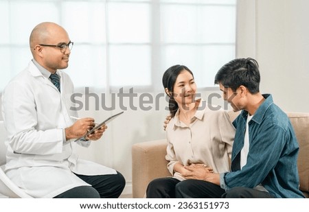 Asian family discussing fertility with a pediatrician. Young couple patients in fertility clinic consulting about IVF or IUI with doctor. Couple relationship therapy with a counselor