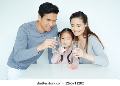 Asian Family Drinking Water With Together