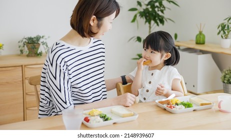 Asian Family Eating In The Living Room