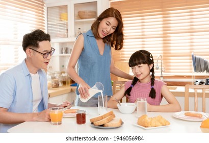 Asian Family Enjoy Eating Breakfast Together In Kitchen Room At Home.