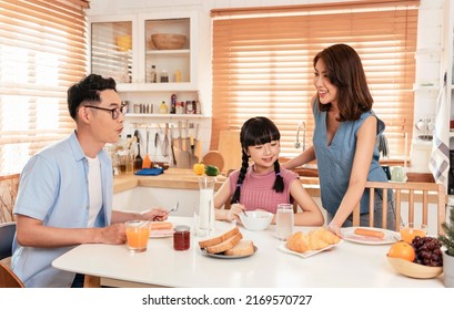 Asian Family Enjoy Eating Breakfast Together In Kitchen Room At Home.
