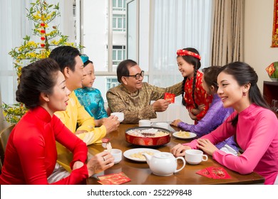 Asian Family Enjoying Tet Celebration At Home