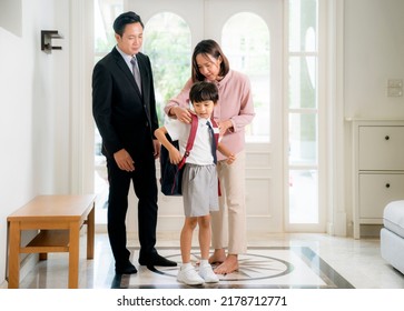 Asian family, father mother and her son go back from school to they home